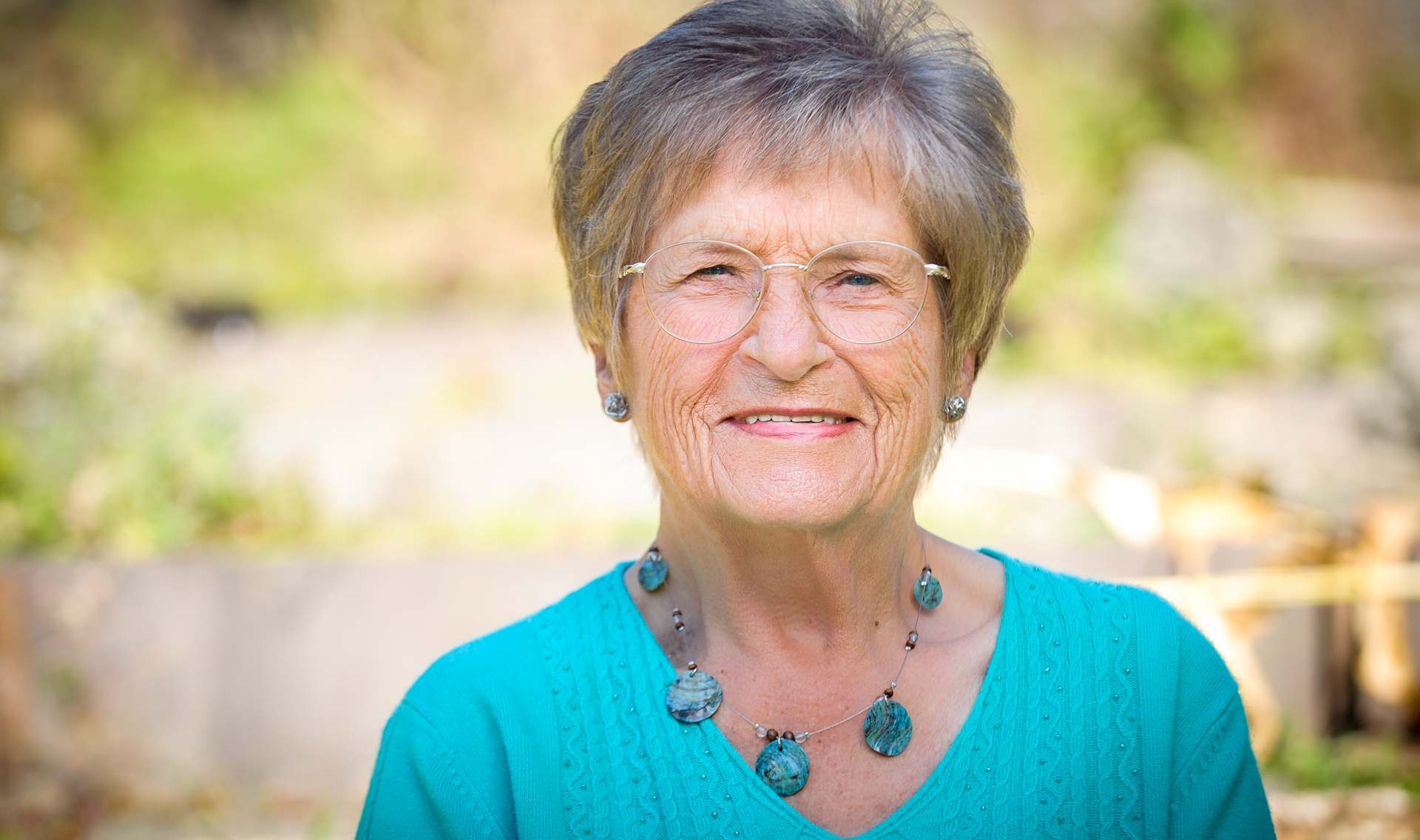 Beautiful portrait of senior grandma in the sun smiling