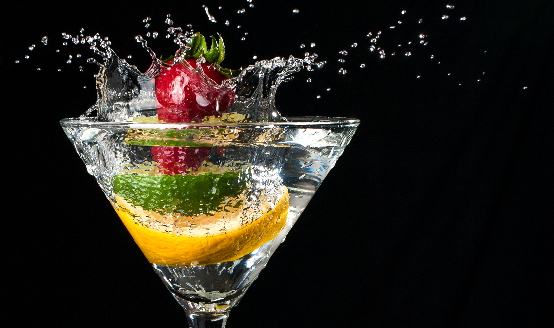 Fruit splashing into a martini glass