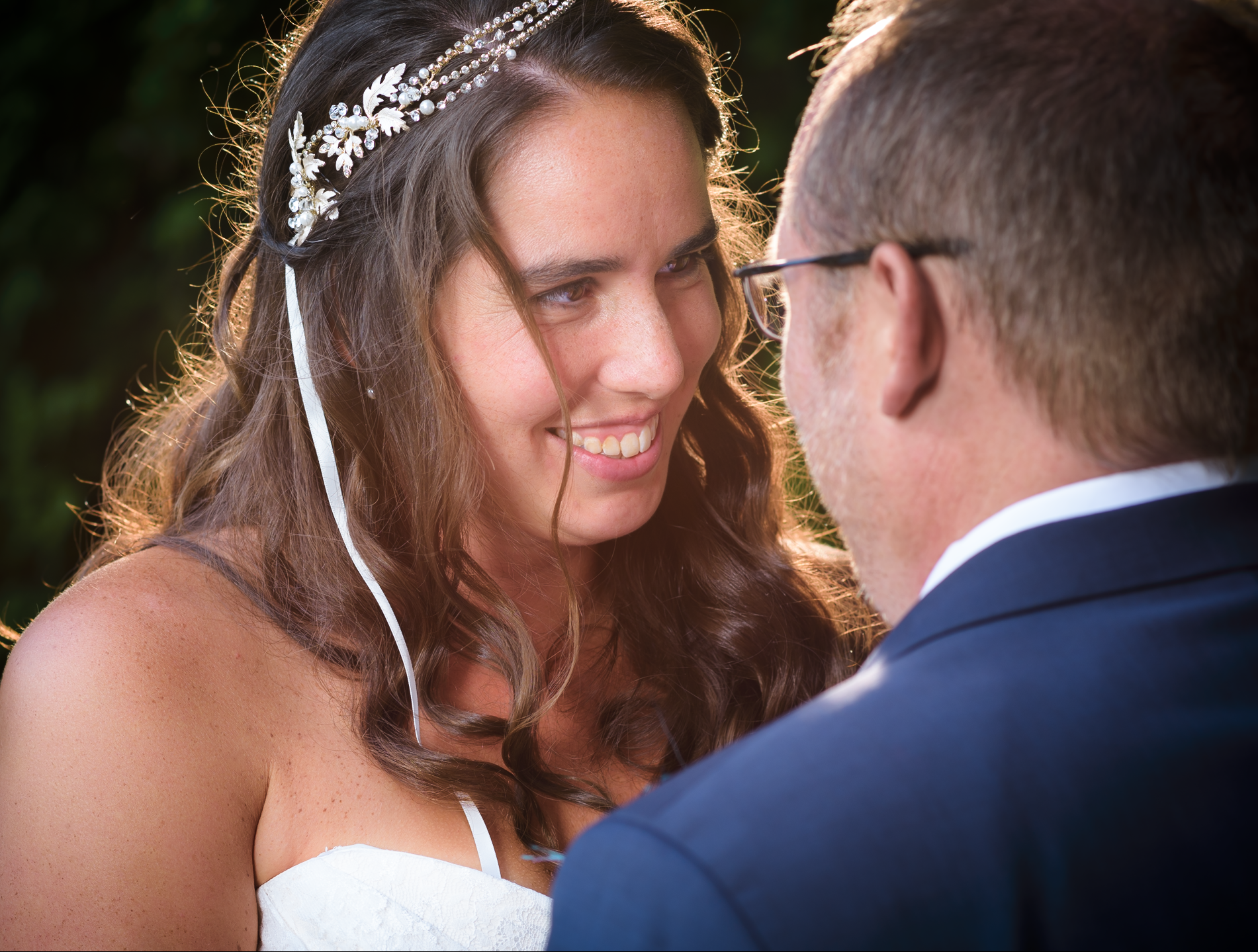 A bride looking longingly into grooms eyes at weeding close up